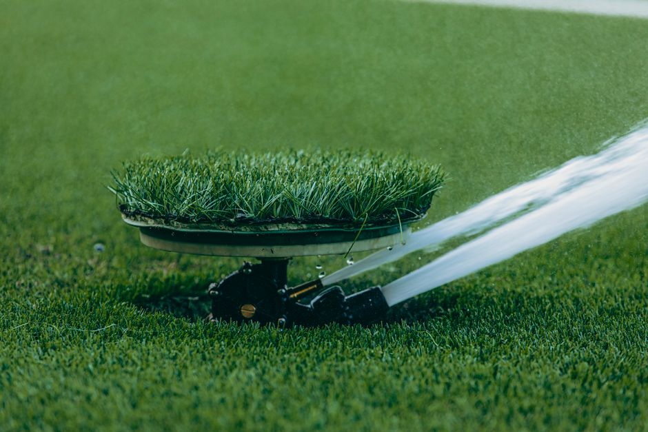 Watering a lush green garden landscape